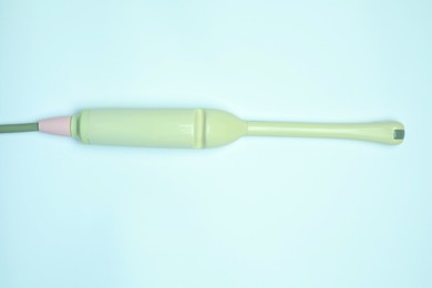 Photo of Ultrasonic transducer on light background, top view