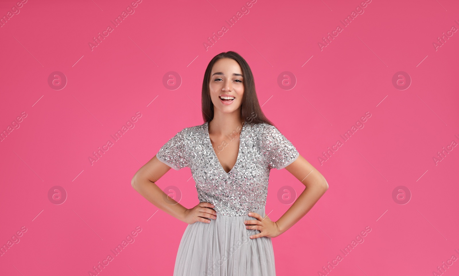 Photo of Young woman wearing stylish dress on pink background