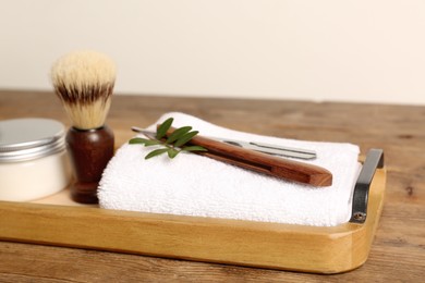 Photo of Set of men's shaving tools on wooden tray