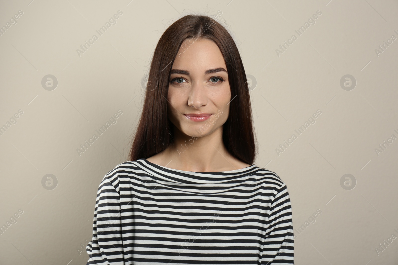 Photo of Portrait of pretty young woman with gorgeous chestnut hair on light background