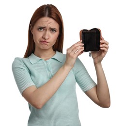 Upset woman with empty wallet on white background