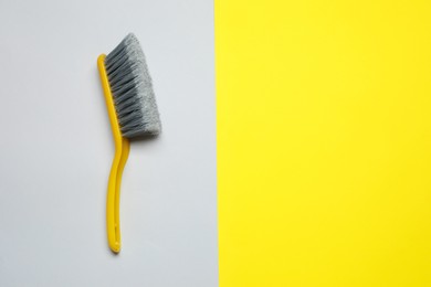Photo of Plastic hand broom on color background, top view. Space for text