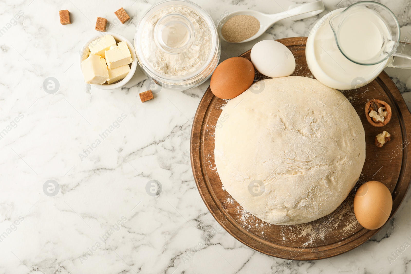 Photo of Flat lay composition with dough for pastries on white marble table. Space for text