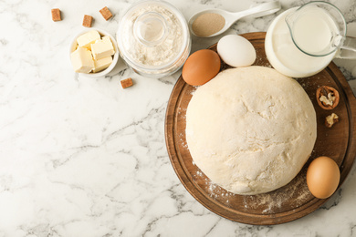 Photo of Flat lay composition with dough for pastries on white marble table. Space for text