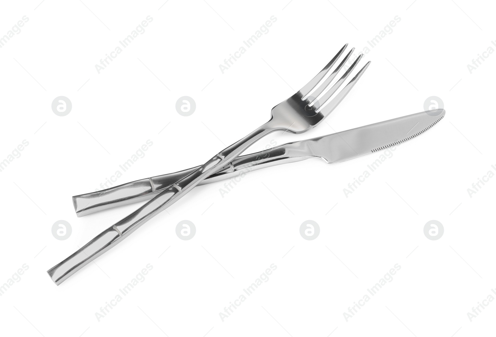 Photo of Fork and knife isolated on white. Stylish shiny cutlery set