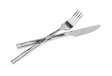 Photo of Fork and knife isolated on white. Stylish shiny cutlery set