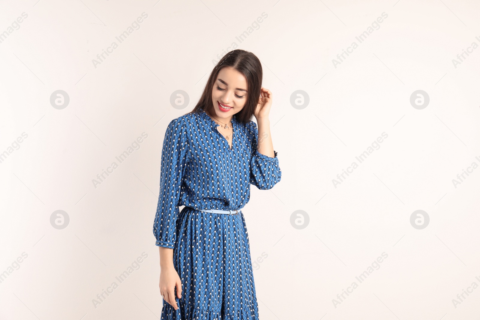 Photo of Portrait of beautiful young woman in stylish dress on white background