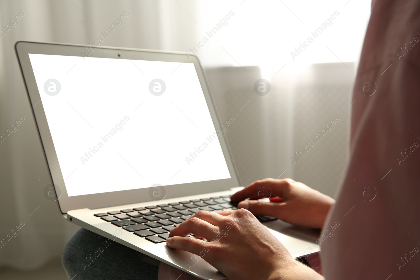 Photo of Woman working with modern laptop indoors, closeup