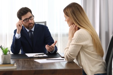 Woman having meeting with lawyer in office, selective focus