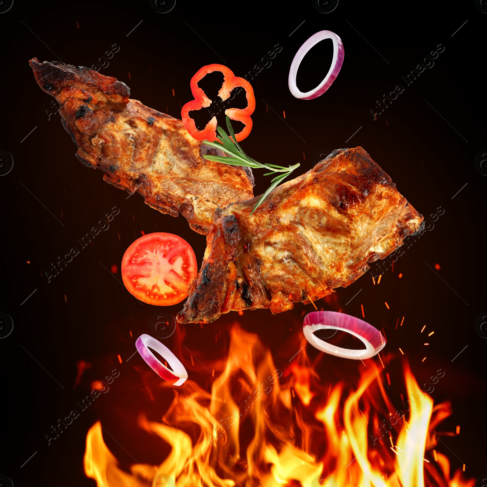 Image of Tasty grilled meat, different vegetables and fire flame on dark background