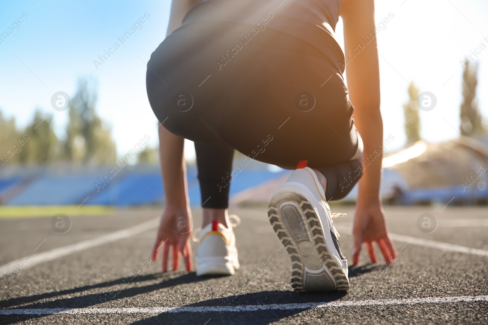 Photo of Sporty woman ready for running at stadium on sunny morning