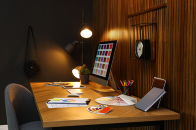 Photo of Modern designer's workplace with computer in office