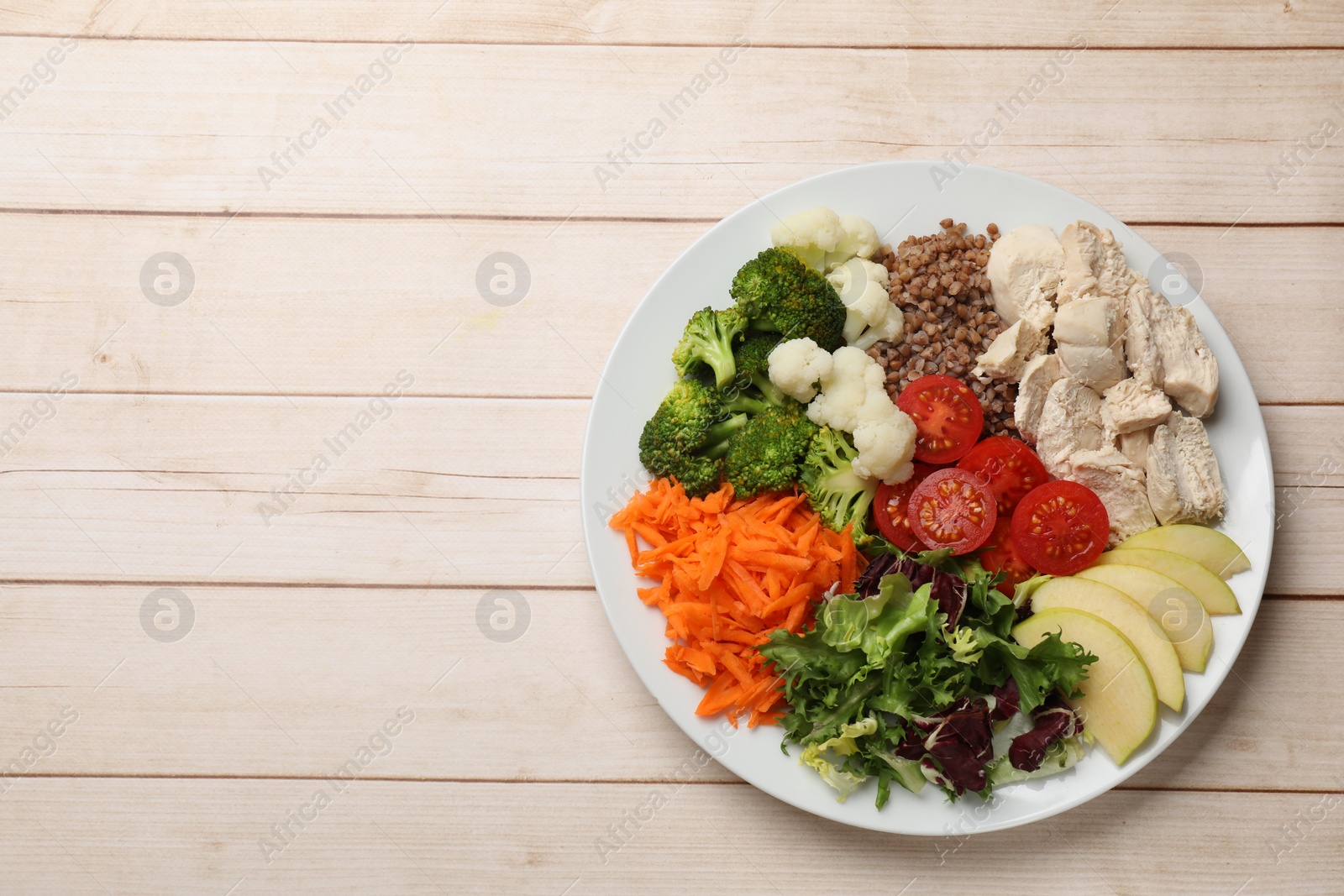 Photo of Balanced diet and healthy foods. Plate with different delicious products on light wooden table, top view. Space for text