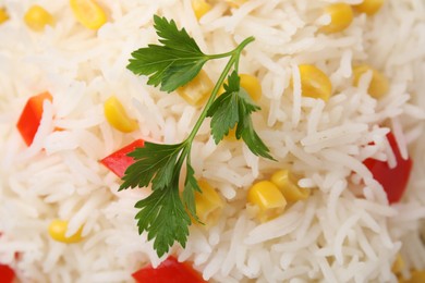 Photo of Delicious rice with vegetables and parsley, top view