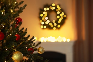 Photo of Beautiful Christmas tree decorated with festive lights and baubles indoors, space for text. Bokeh effect