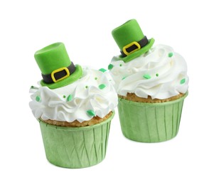 Photo of St. Patrick's day party. Tasty cupcakes with green leprechaun hat toppers and sprinkles isolated on white