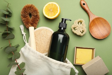 Photo of Flat lay composition with eco friendly products on green background