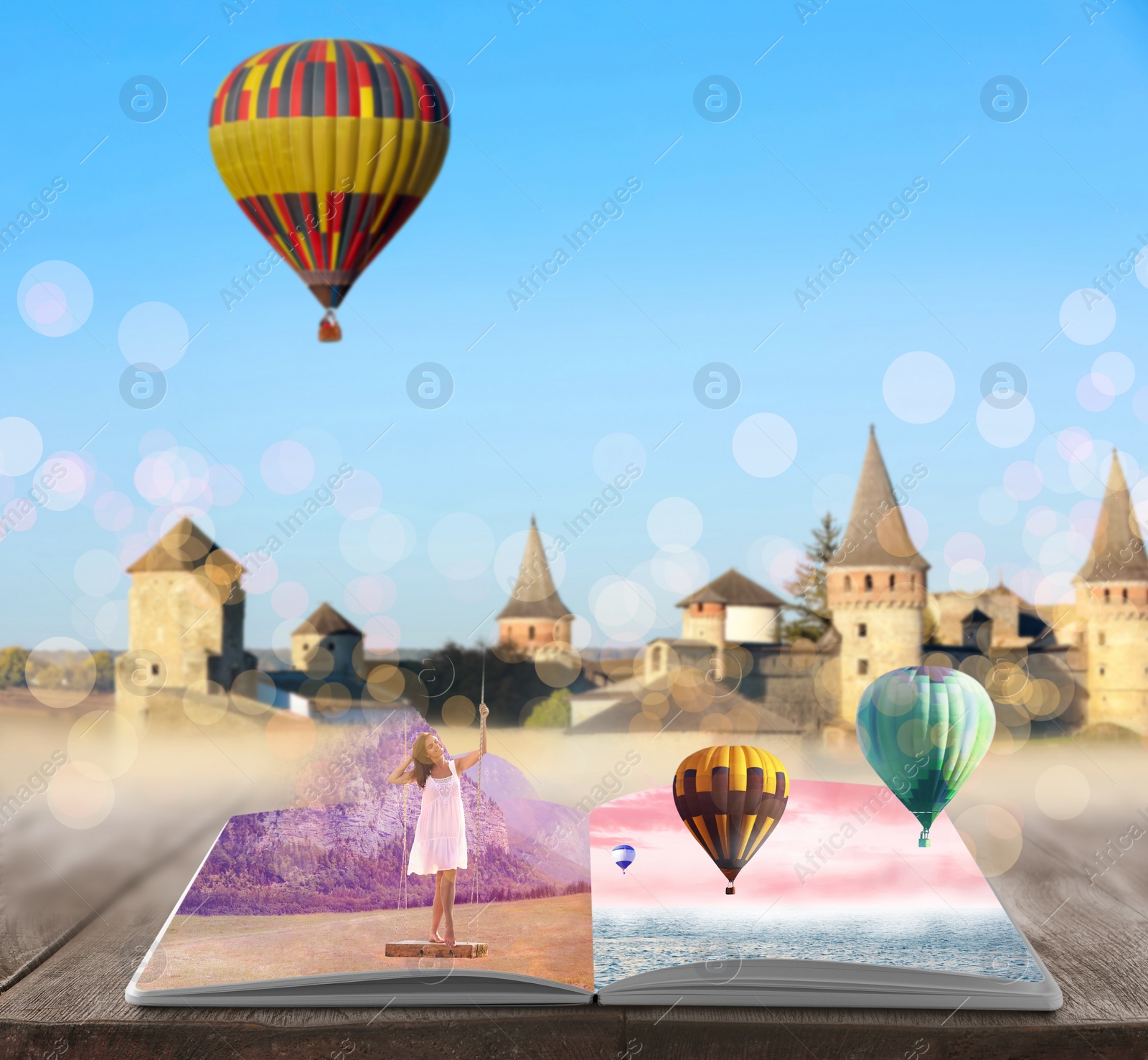 Image of Fantasy worlds in fairytales. Book, hot air balloons and enchanted castle on background