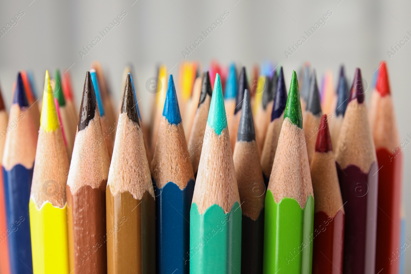 Photo of Different color pencils on white background, closeup view