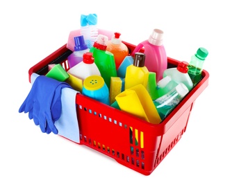 Shopping basket with different detergents, rag and gloves on white background