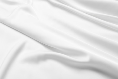 Photo of Texture of white silk ripple fabric as background, closeup