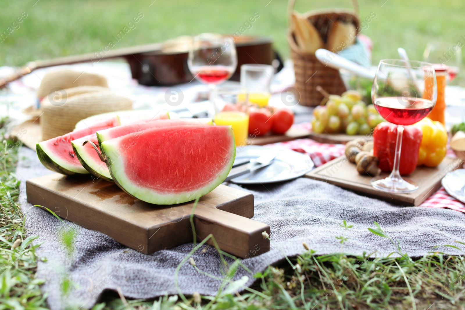 Photo of Blanket with food prepared for summer picnic outdoors