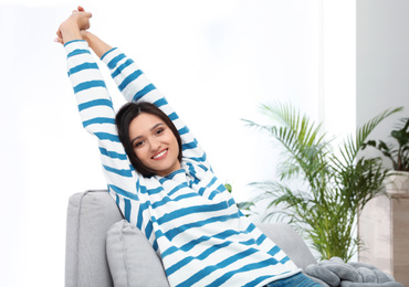 Young woman relaxing on couch at home