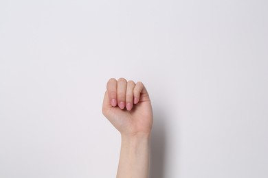 SOS gesture. Woman showing signal for help on white background, closeup