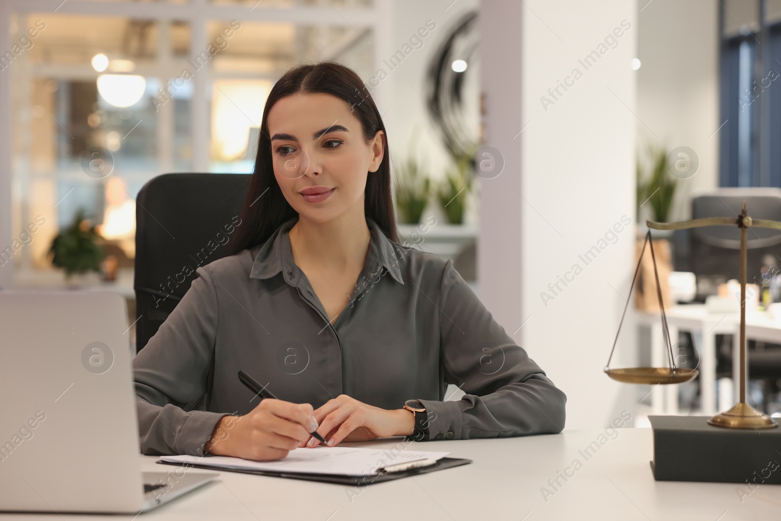 Photo of Portrait of confident lawyer working at table in office