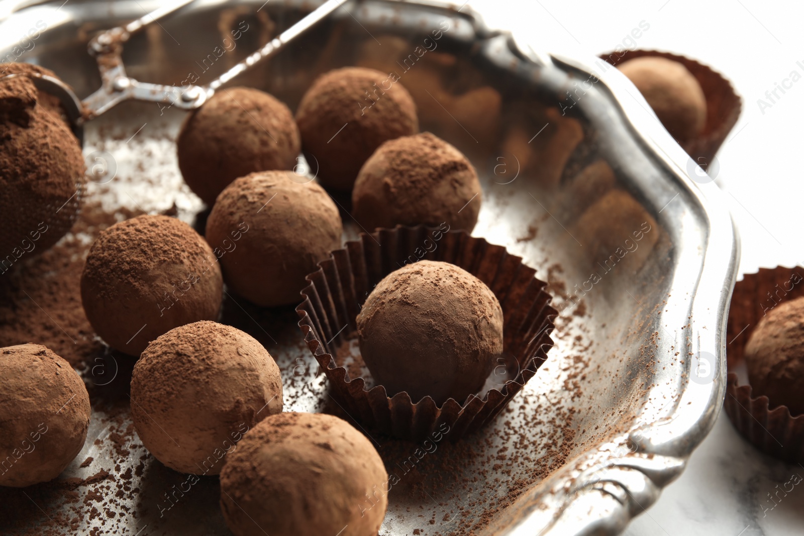 Photo of Plate with tasty chocolate truffles on table, closeup