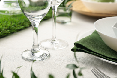 Photo of Clean glasses on table, closeup. Festive setting