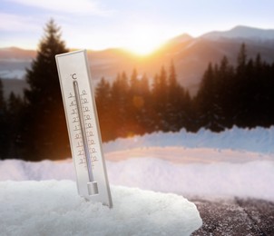 Thermometer in snow showing temperature below zero outdoors on winter day