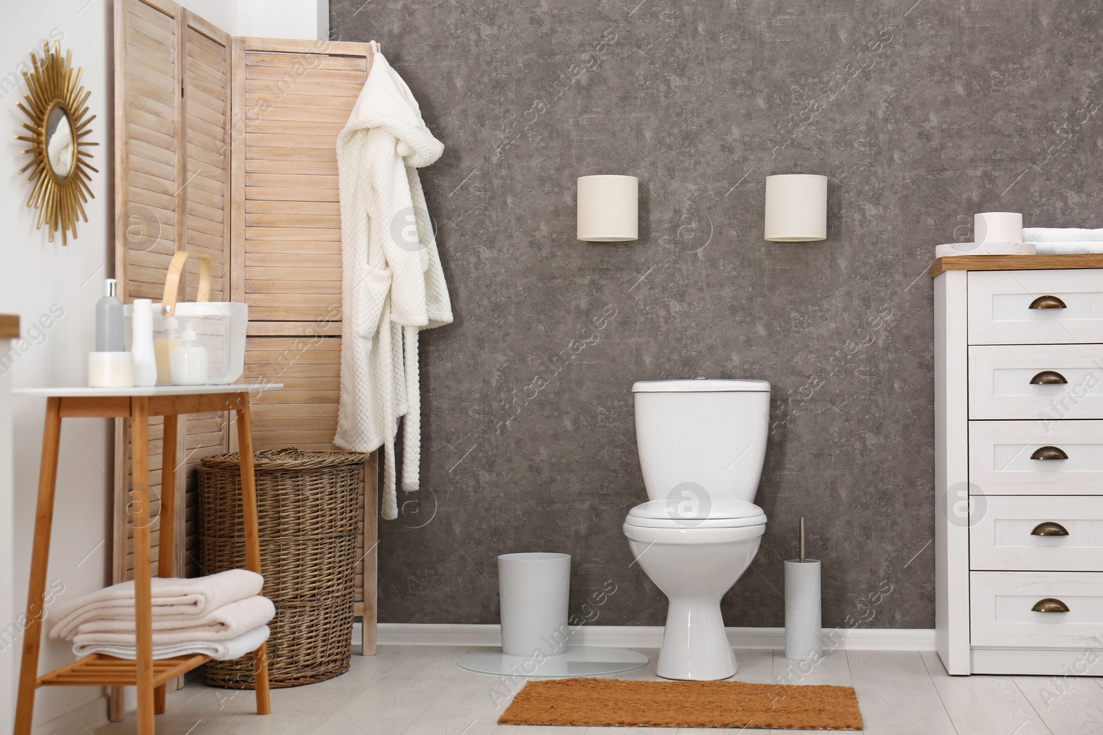 Photo of Ceramic toilet bowl in stylish bathroom. Idea for interior design