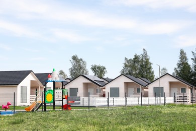 Photo of Beautiful view of modern houses and playground outdoors
