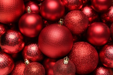 Red Christmas balls as background, top view