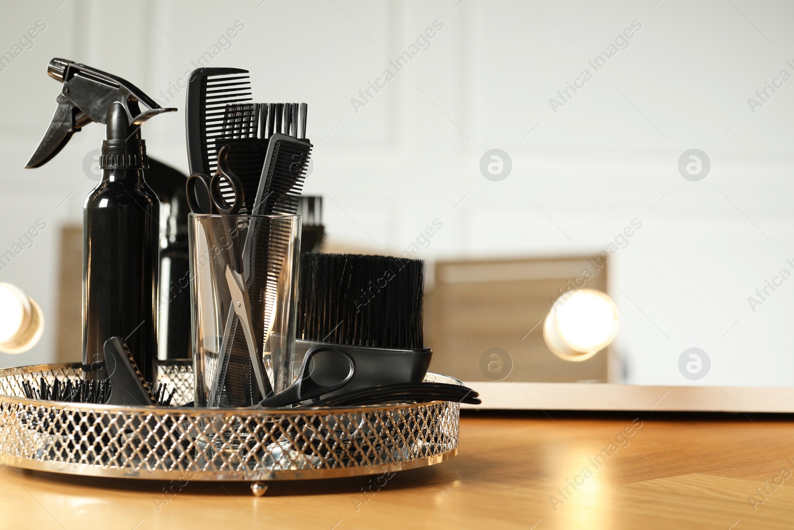 Photo of Set of hairdresser tools on table in salon. Space for text