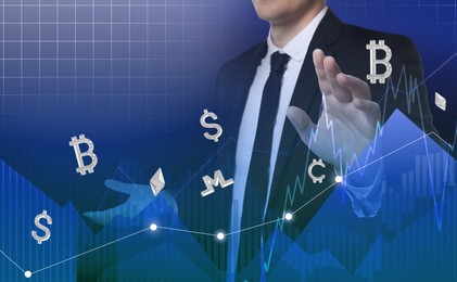 Cryptocurrency. Businessman using virtual screen with symbols and data charts on blue background, closeup