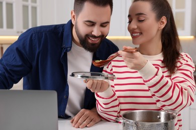 Photo of Happy lovely couple cooking together in kitchen