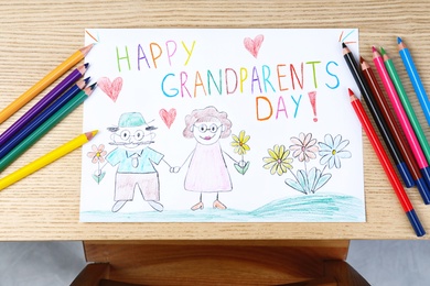 Photo of Beautiful drawing on wooden table, top view. Happy Grandparents Day