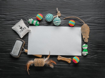 Photo of Flat lay composition with cat accessories on dark wooden background