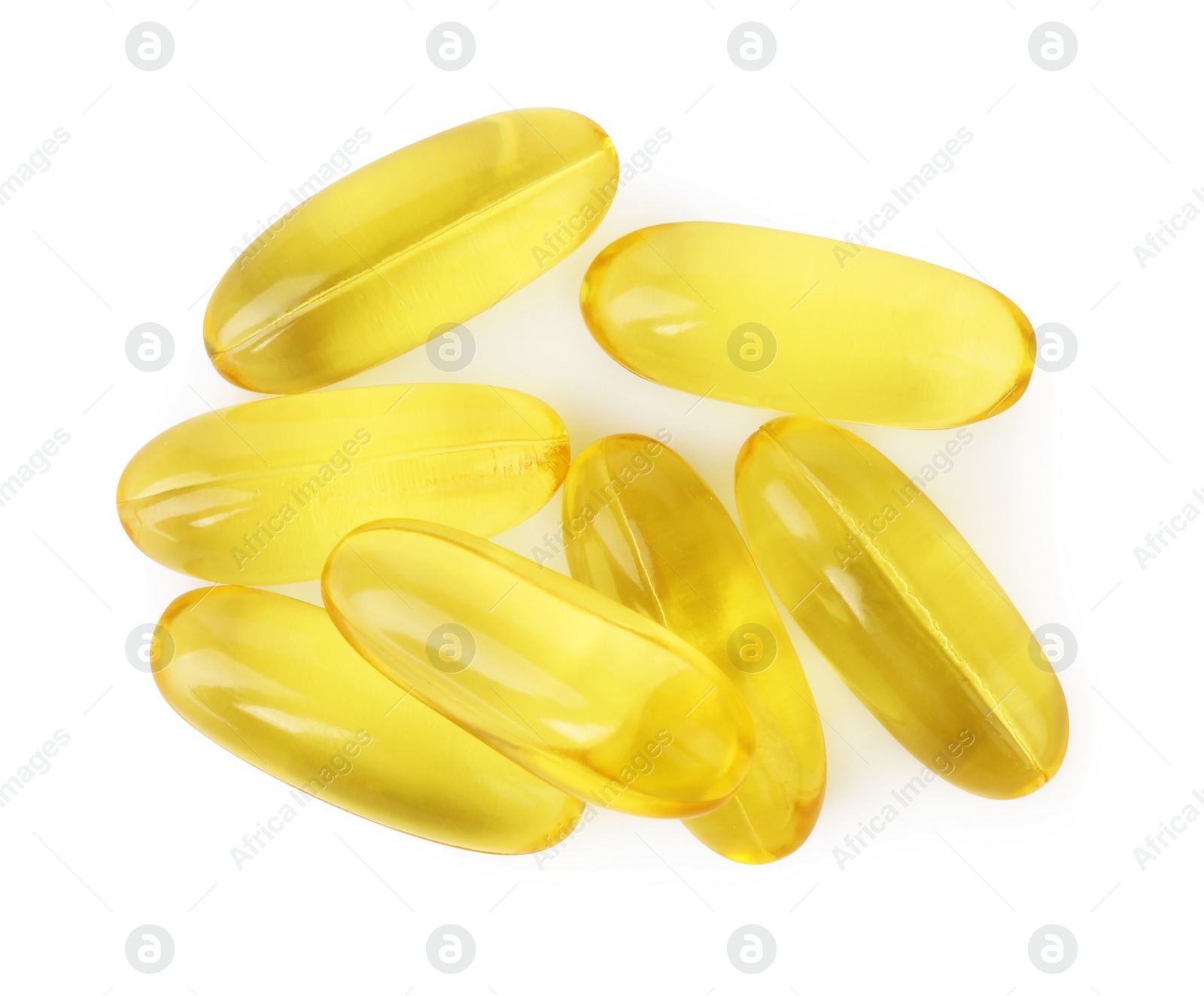 Photo of Many yellow vitamin capsules isolated on white, top view