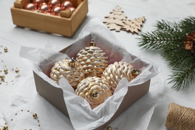Photo of Composition with beautiful Christmas baubles on white wooden table