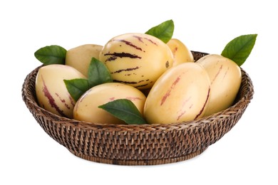 Photo of Fresh ripe pepino melons with green leaves in wicker bowl on white background