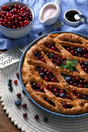 Photo of Delicious currant pie with fresh berries on wooden table