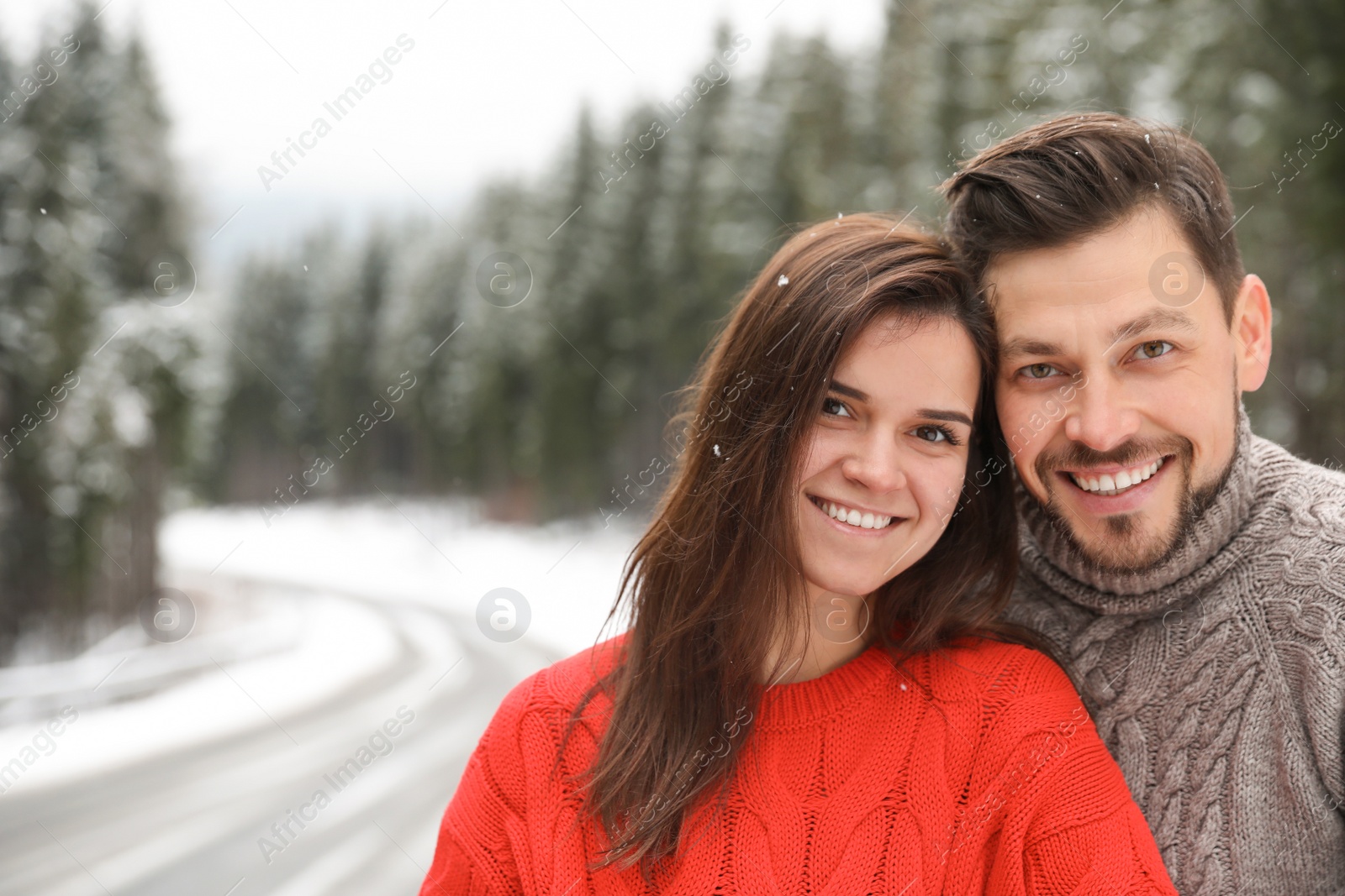 Photo of Cute couple outdoors on snowy day, space for text. Winter vacation