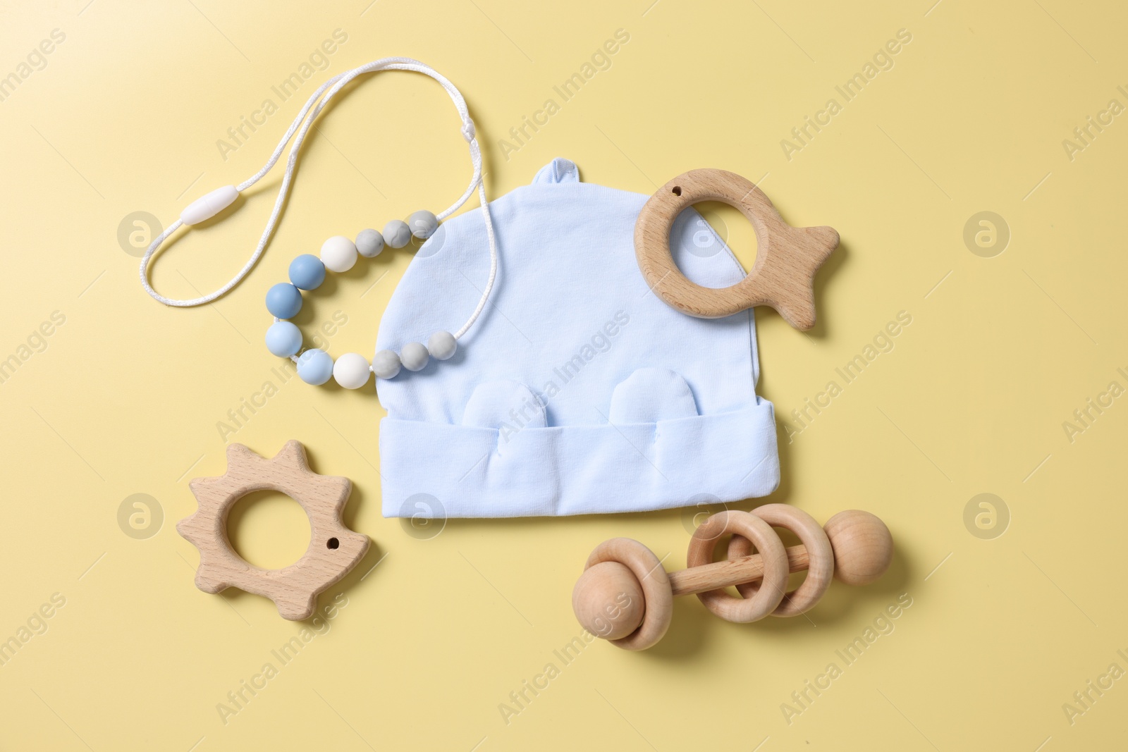 Photo of Different baby accessories on yellow background, flat lay