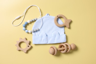 Photo of Different baby accessories on yellow background, flat lay