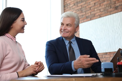 Senior notary working with client in office