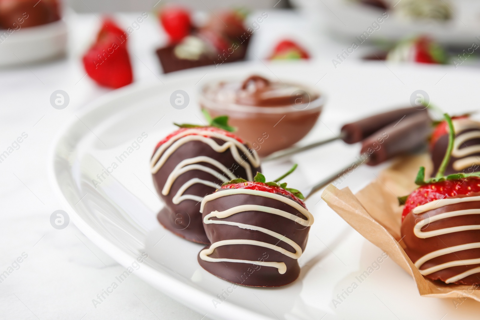 Photo of Plate with chocolate covered strawberries on table, closeup