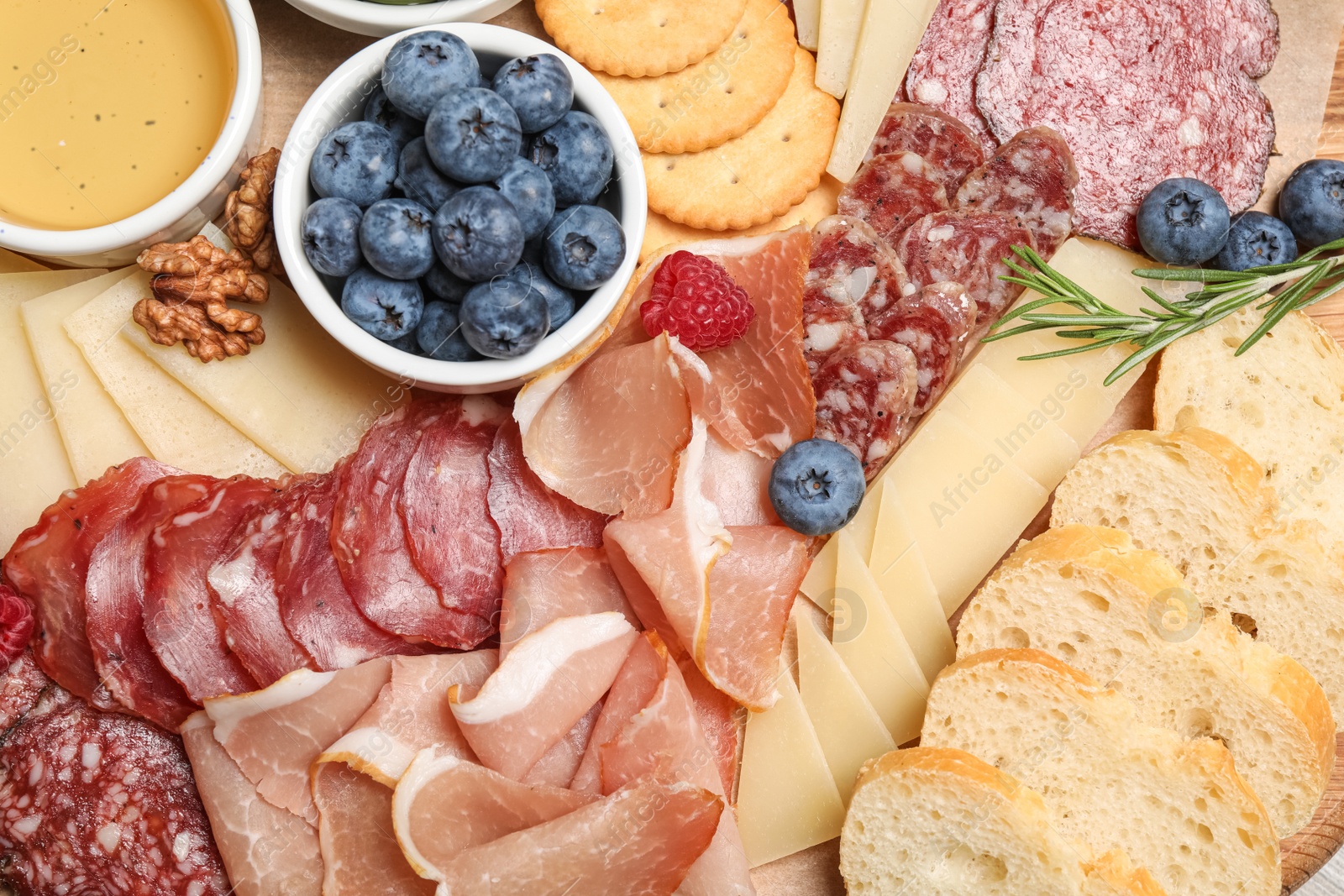 Photo of Tasty parmesan cheese and other different appetizers as background, top view